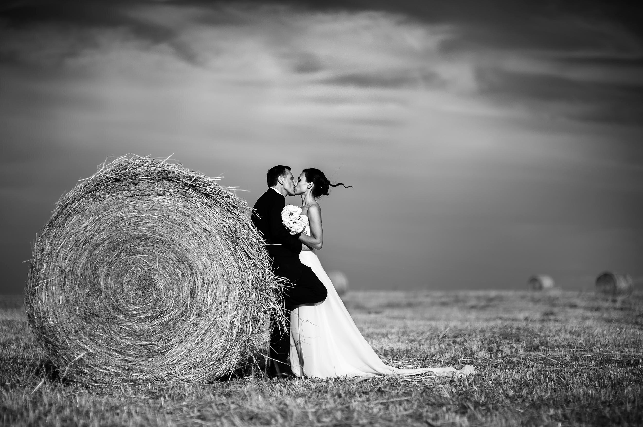 Bride and groom with hay bales