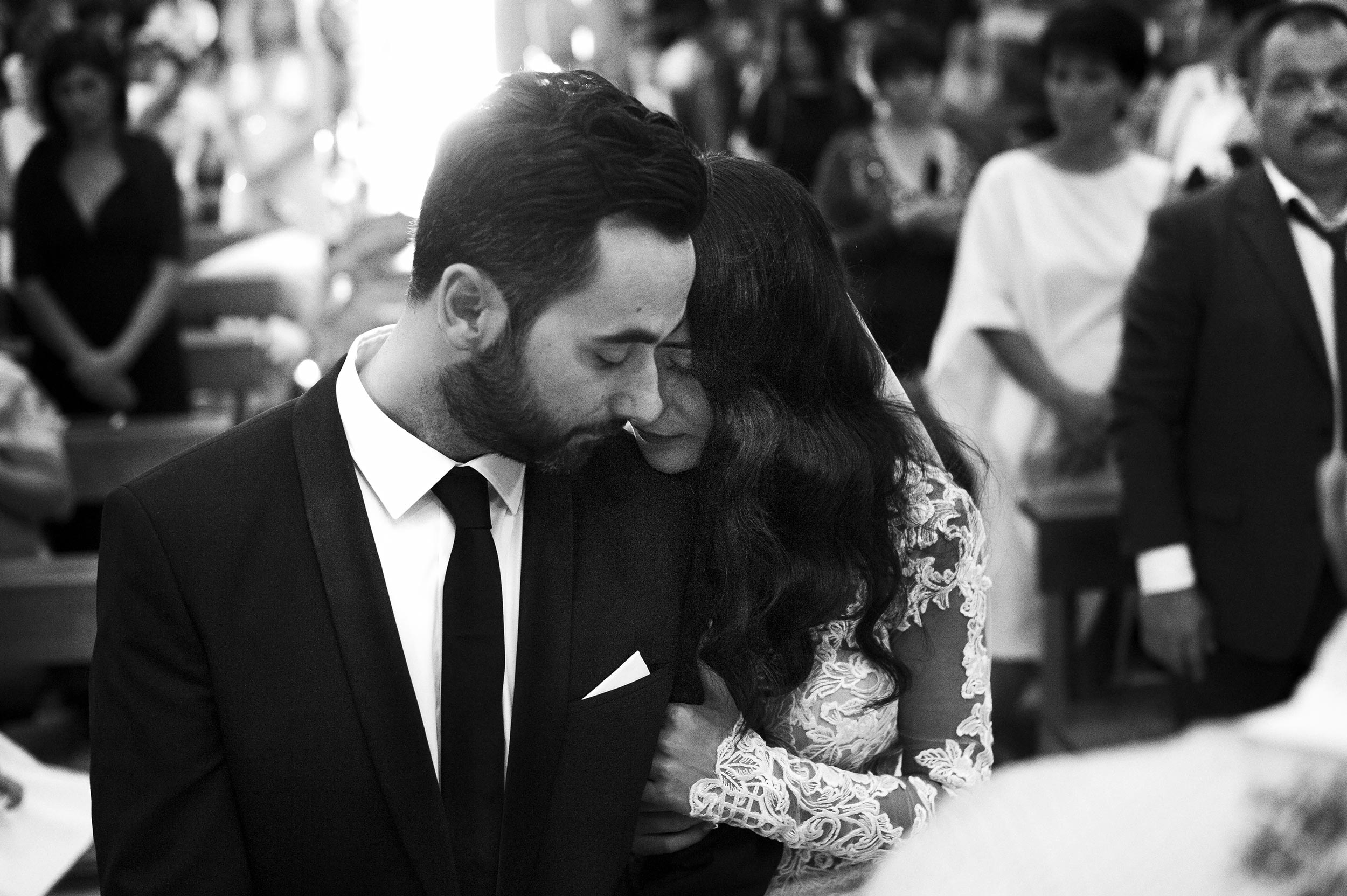 a tender moment during ceremony in italy black and white wedding photography