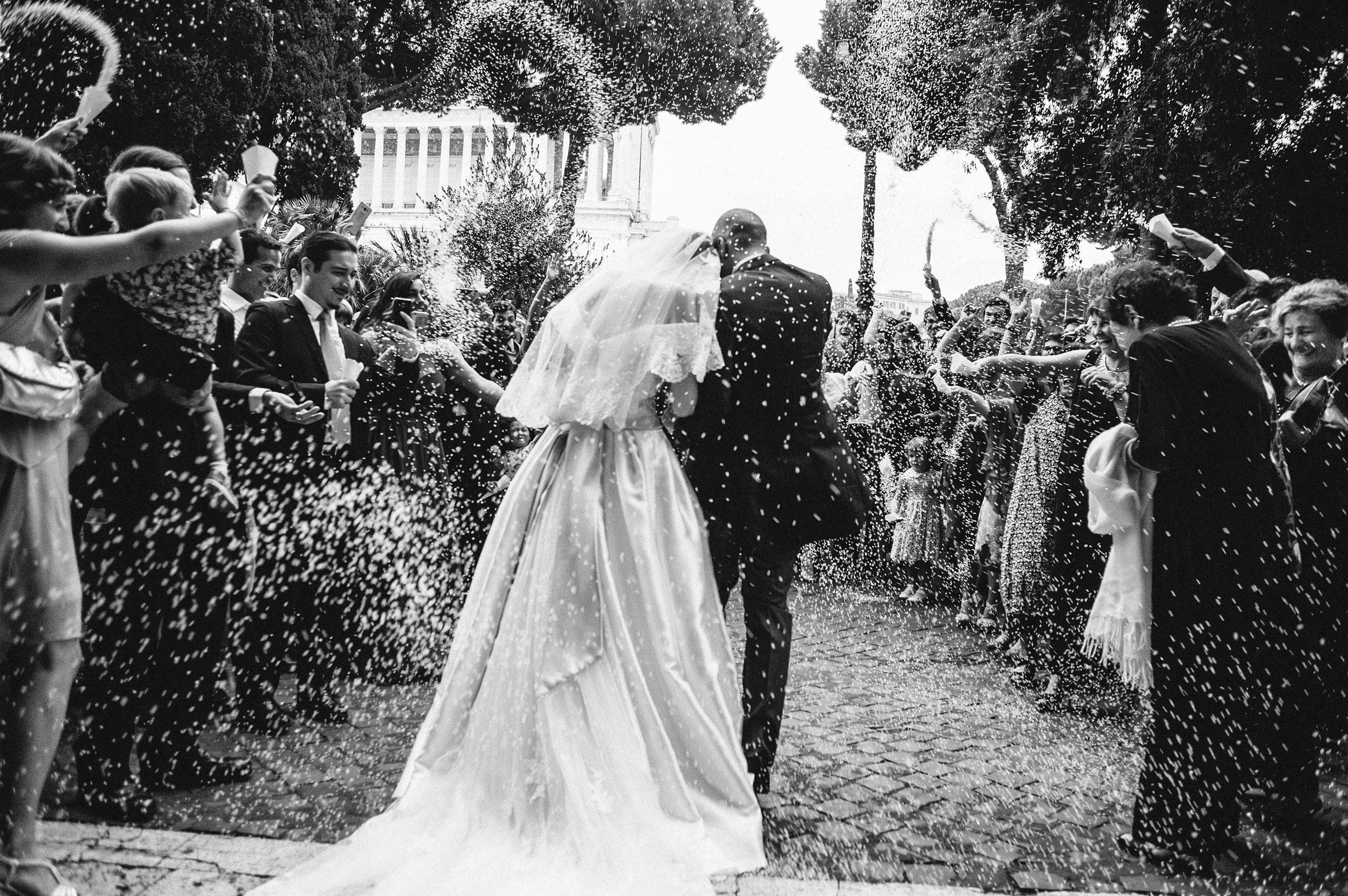confetti rice outside the church rome san marco black and white wedding photography