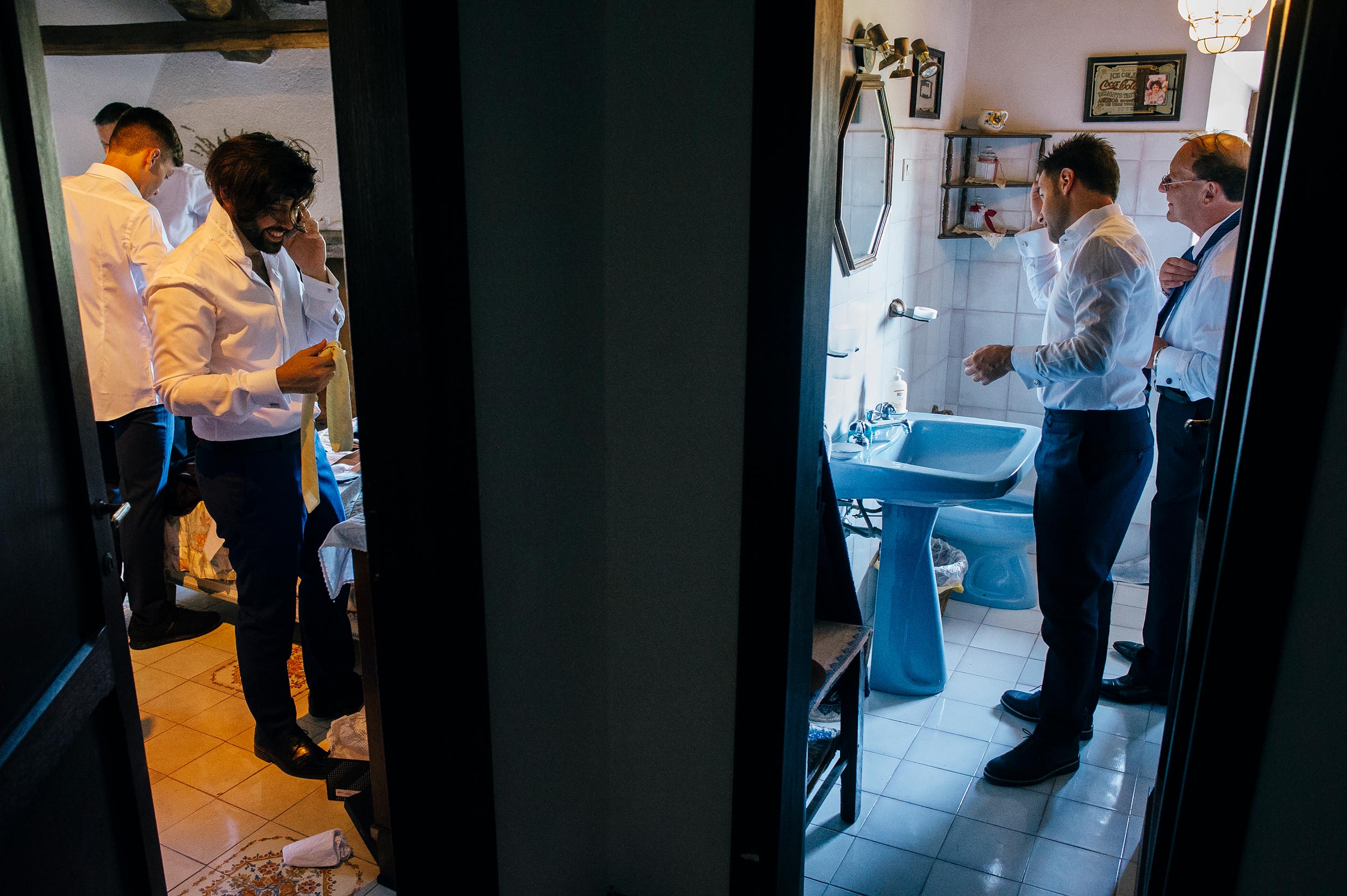 groom his dad and other men getting ready before wedding in italy