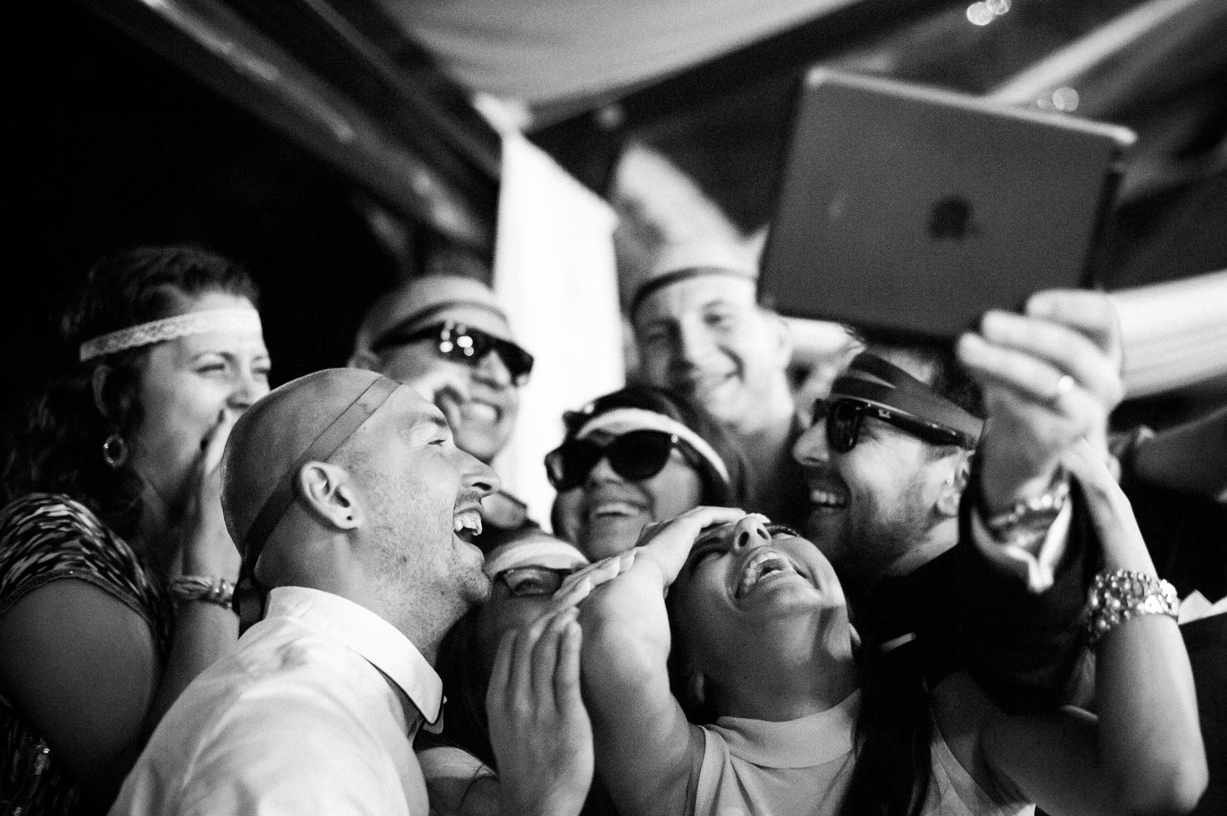 guests having fun with selfies at wedding reception in rome italy black and white wedding photography