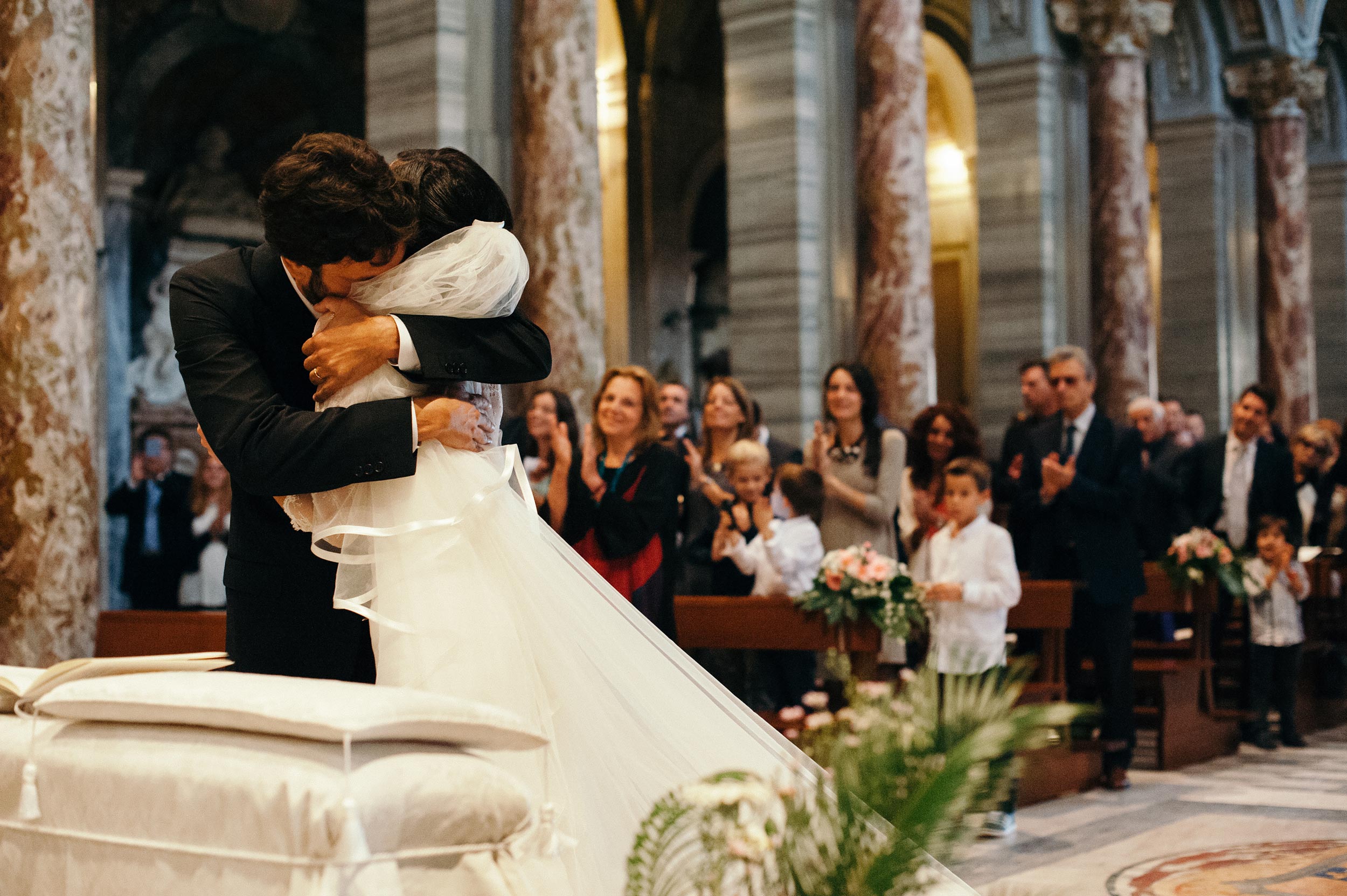 groom hugs the bride in great emotion during ceremony wedding in rome italy
