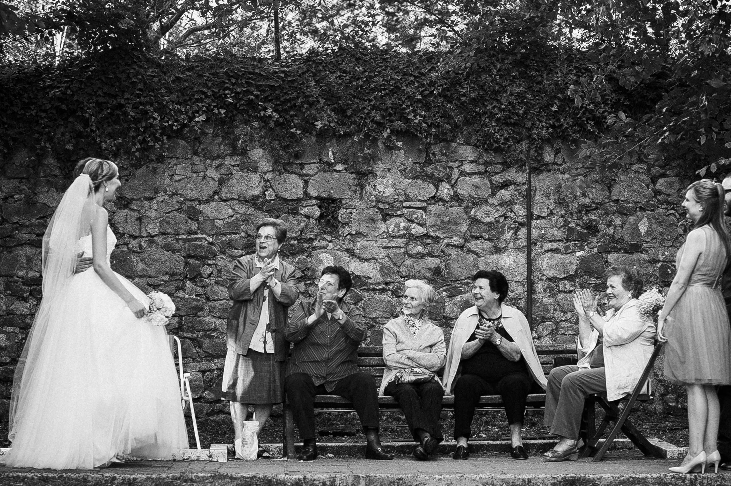 bride and groom meet old ladies wedding in italy local people black and white wedding photography