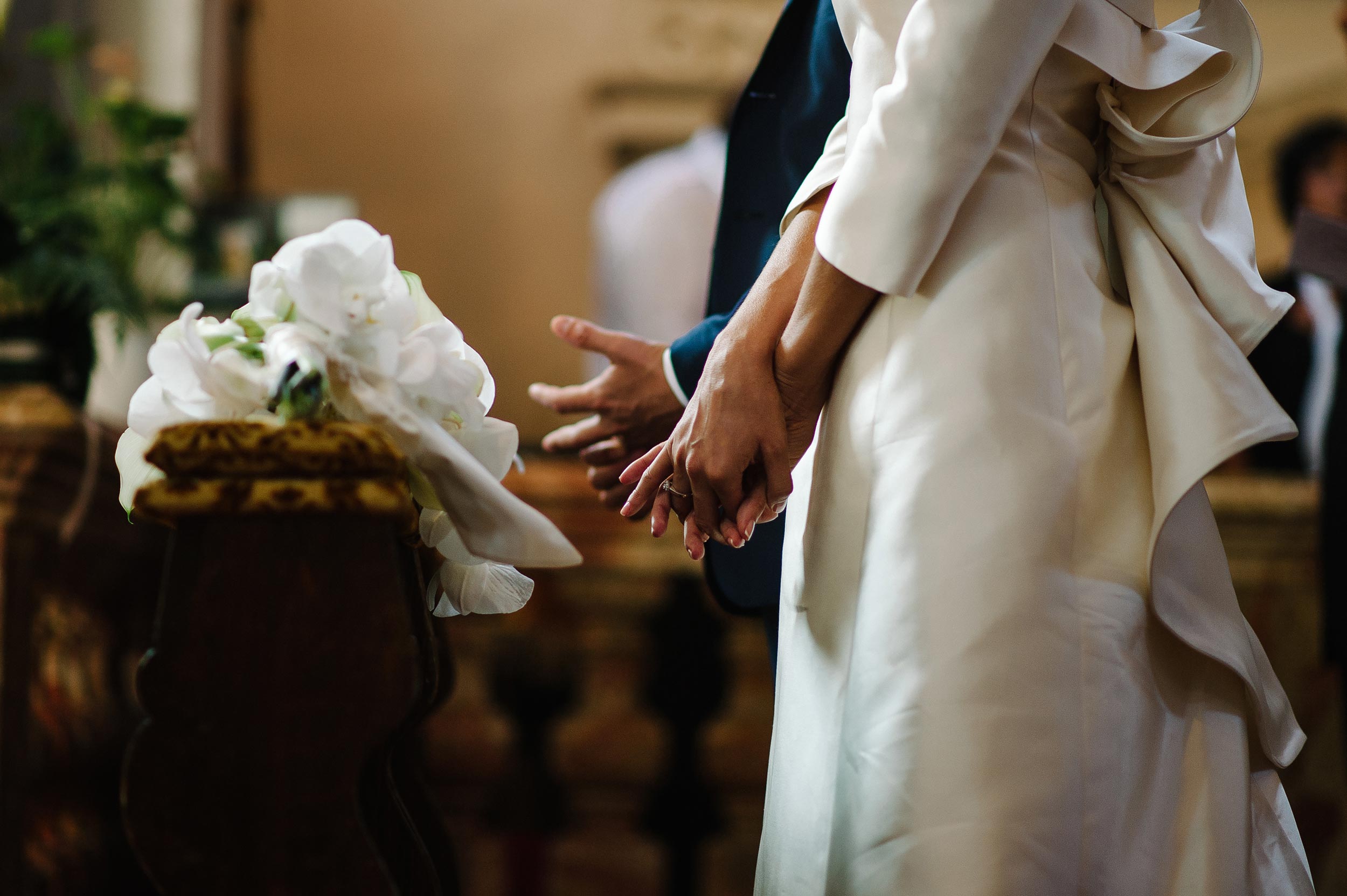 bride and groom hands touching their rings after rings exchange lugano switzerlang