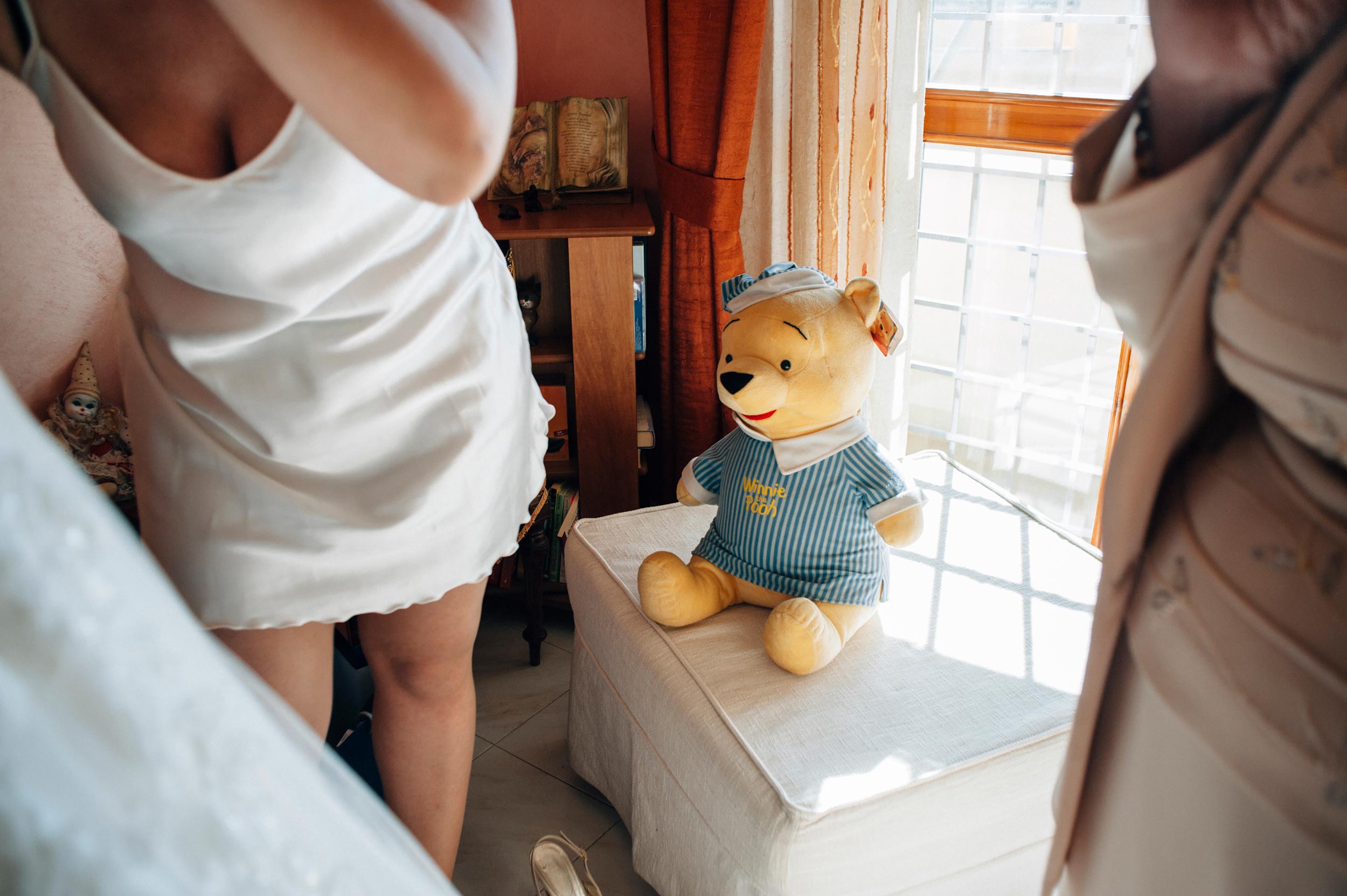 astonished winnie the pooh looks at the bride getting ready in underwear