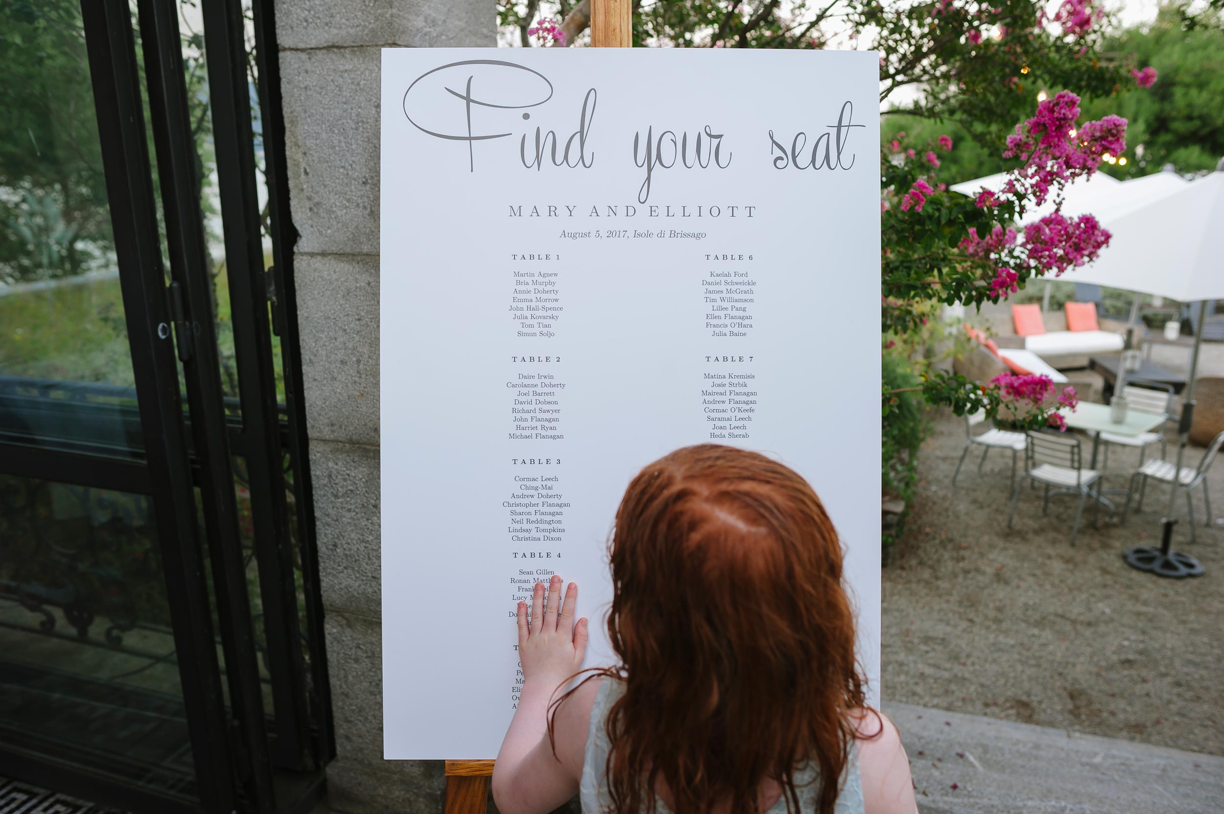 girl looking at tableau marriage finding her seat