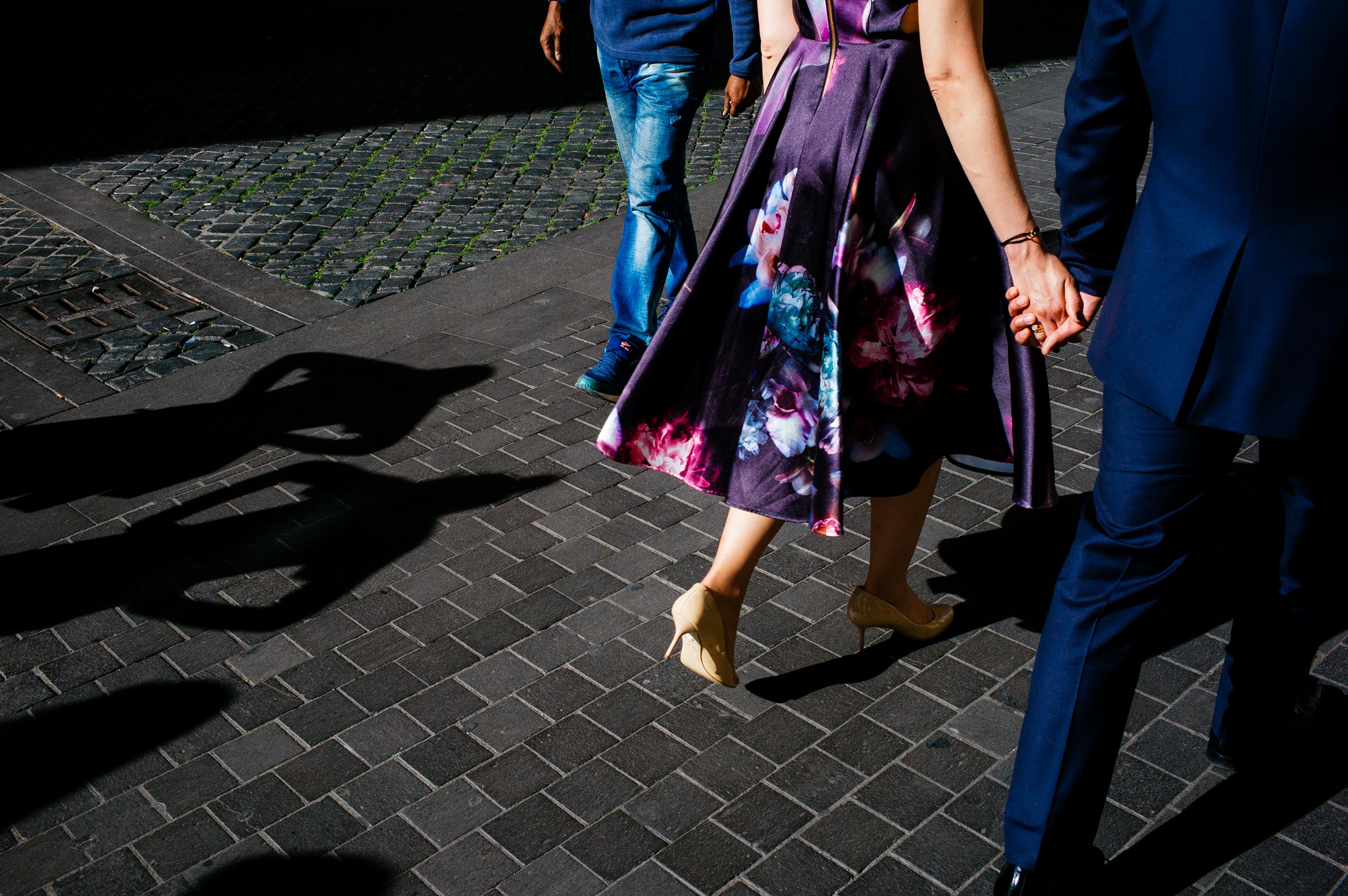 Engagement in Rome - couple walking, shadow of passersby watching