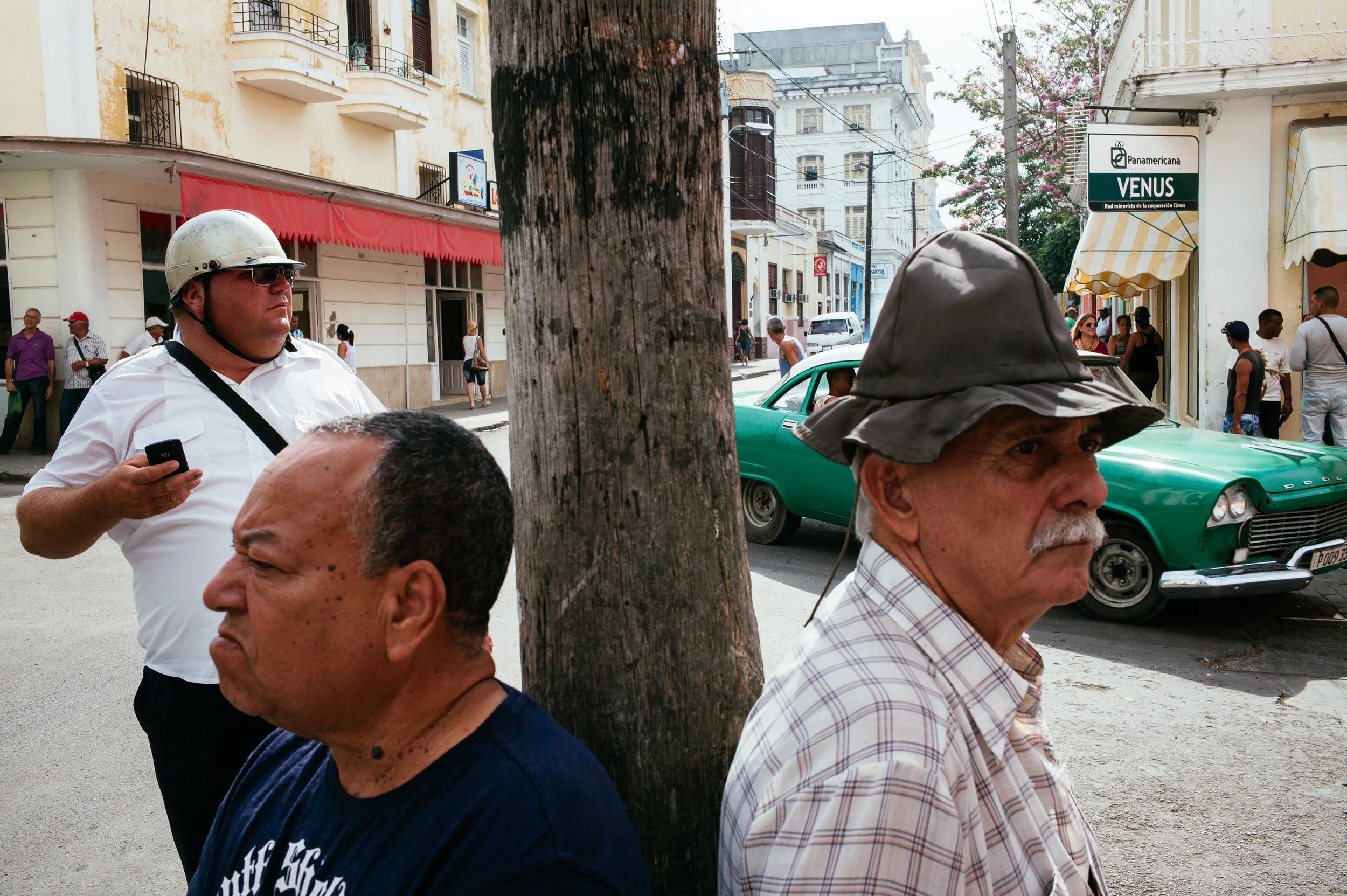 Cienfuegos 2016 - Men standing by a pole