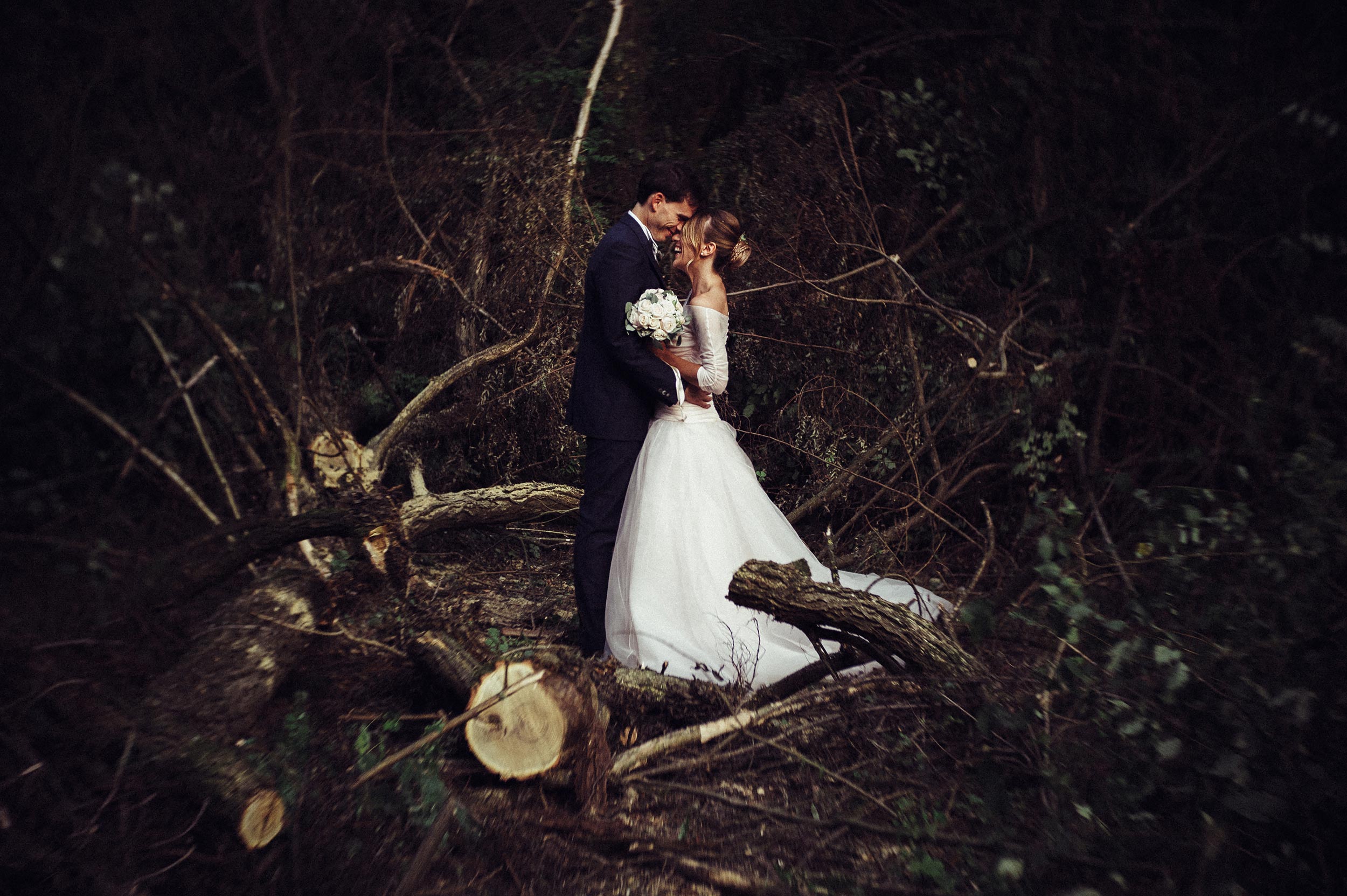 wedding couple in the woods smiling